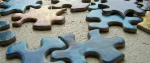 Puzzle pieces scattered on a table_canstockphoto187456 760x320